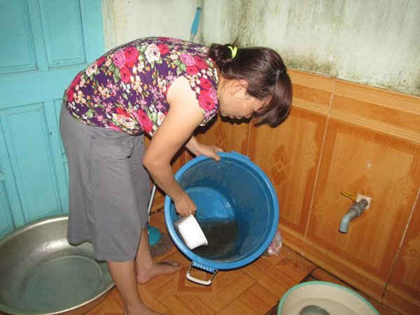  Chị Nguyệt dùng lại nước rửa rau để rửa chén