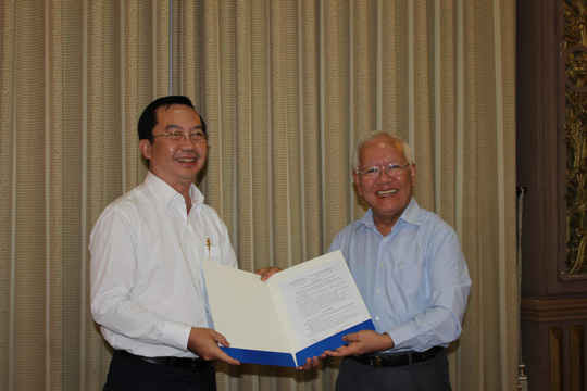 Ông Trần Thế Thuận (trái) nhận quyết định bổ nhiệm chức Chủ tịch UBND quận 1