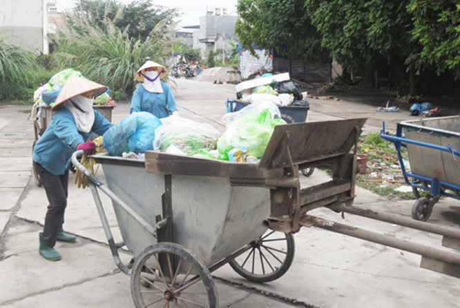 Công nhân HTX Dịch vụ môi trường thị trấn Minh Tân thu gom rác thải
