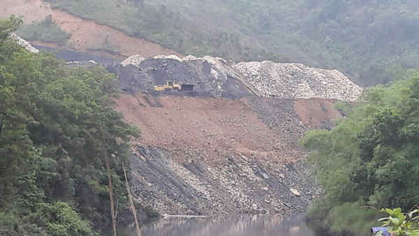 Đất đá bóc phủ đổ đầy ven sông, gây ô nhiễm môi trường