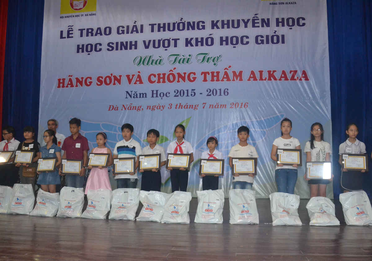 Các em học sinh đạt thành tích xuất sắc trong học tập vui mừng trước phần thưởng của nhà tài trợ