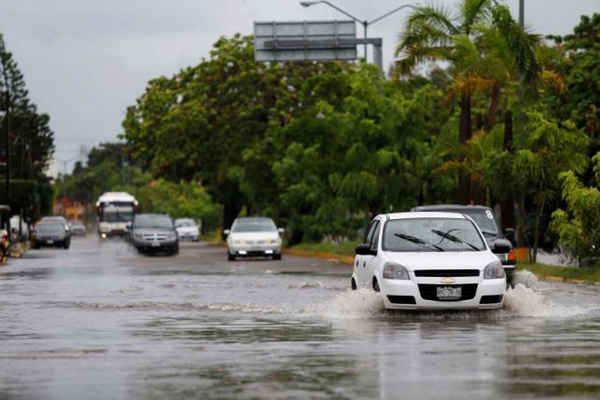 Những chiếc ô tô đi qua con đường ngập lụt khi bán đảo Baja California của Mexico chuẩn bị đón cơn bão nhiệt đới Javier ở Mazatlan, Mexico vào ngày 8/8/2016. Ảnh: REUTERS/EDUARDO RESENDIZ