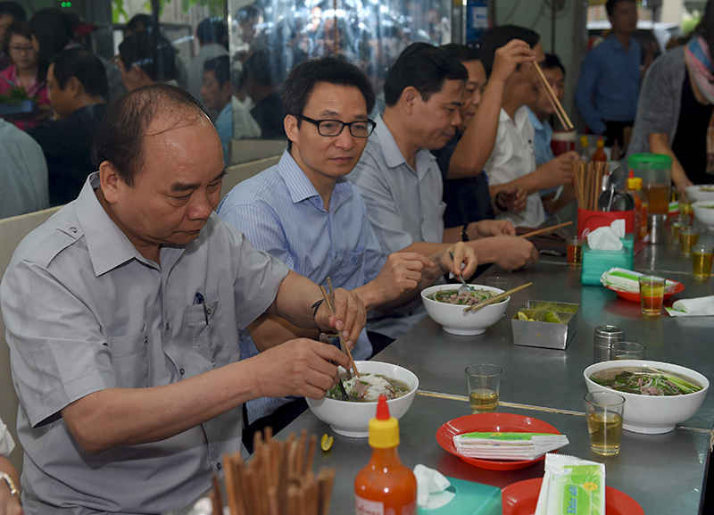 Thủ tướng và đoàn kiểm tra dừng chân, dùng điểm tâm tại một quán ăn đường phố thuộc phường Tân Thành, TPHCM.