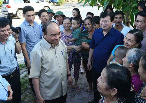 Thủ tướng Nguyễn Xuân Phúc thăm hỏi, trò chuyện với người dân tái định cư phường Noong Bua (thị xã Mường Lay, tỉnh Điện Biên).  Ảnh: VGP