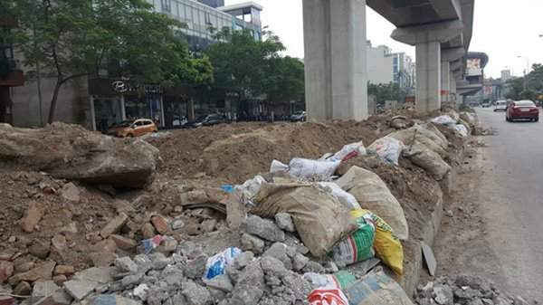 Phế thải xây dựng đổ tràn trên dải phân cách ở phố Hoàng Cầu (quận Đống Đa).