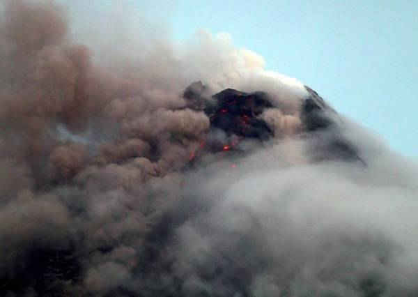 Các đám mây bao phủ một phần miệng núi lửa Mayon khi ngọn núi lửa này phun ra cột tro ở thành phố Legazpi, tỉnh Albay, phía Nam Manila, Philippines vào ngày 16/1/2018. Ảnh: Reuters / Stringer