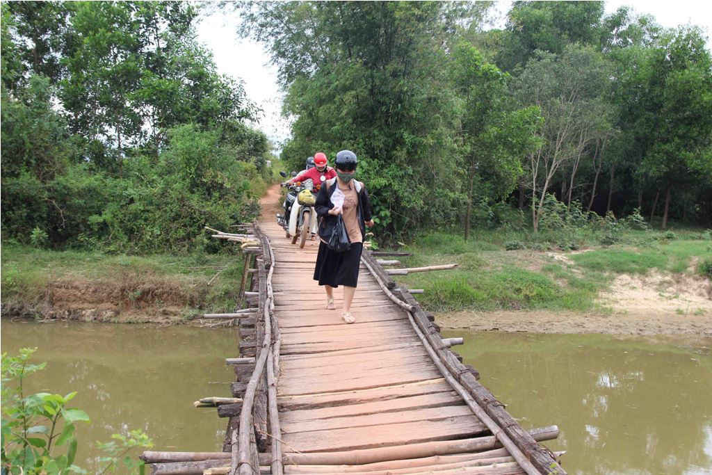 Người dân phải đi qua một chiếc cầu tạm bằng gỗ, không lan can...