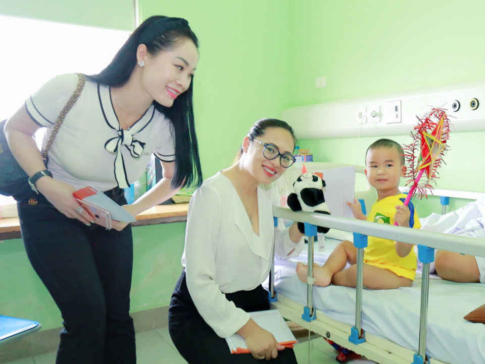 Doanh nhân Nguyễn Thanh Hoa (bìa trái) tươi cười khi trao quà