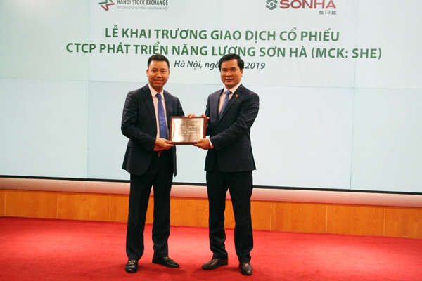 Ông Nguyễn Như Quỳnh – Thành viên HĐQT kiêm Phó Tổng Giám đốc Sở Giao dịch chứng khoán Hà Nội trao chứng nhận niêm yết cổ phiếu và hoa chúc mừng cho CTCP Phát triển năng lượng Sơn Hà